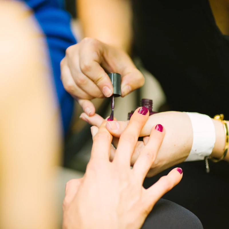 Manicurist painting nails