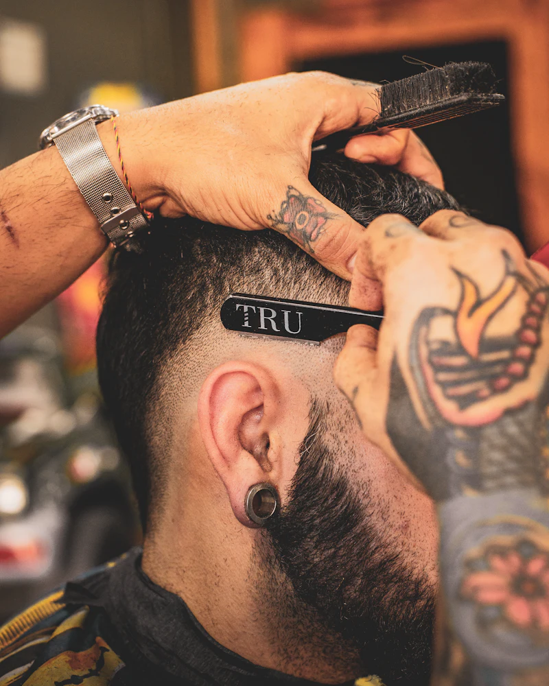 Barber shaping a man's beard